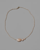 Nereus Pearl Necklace on light color background.