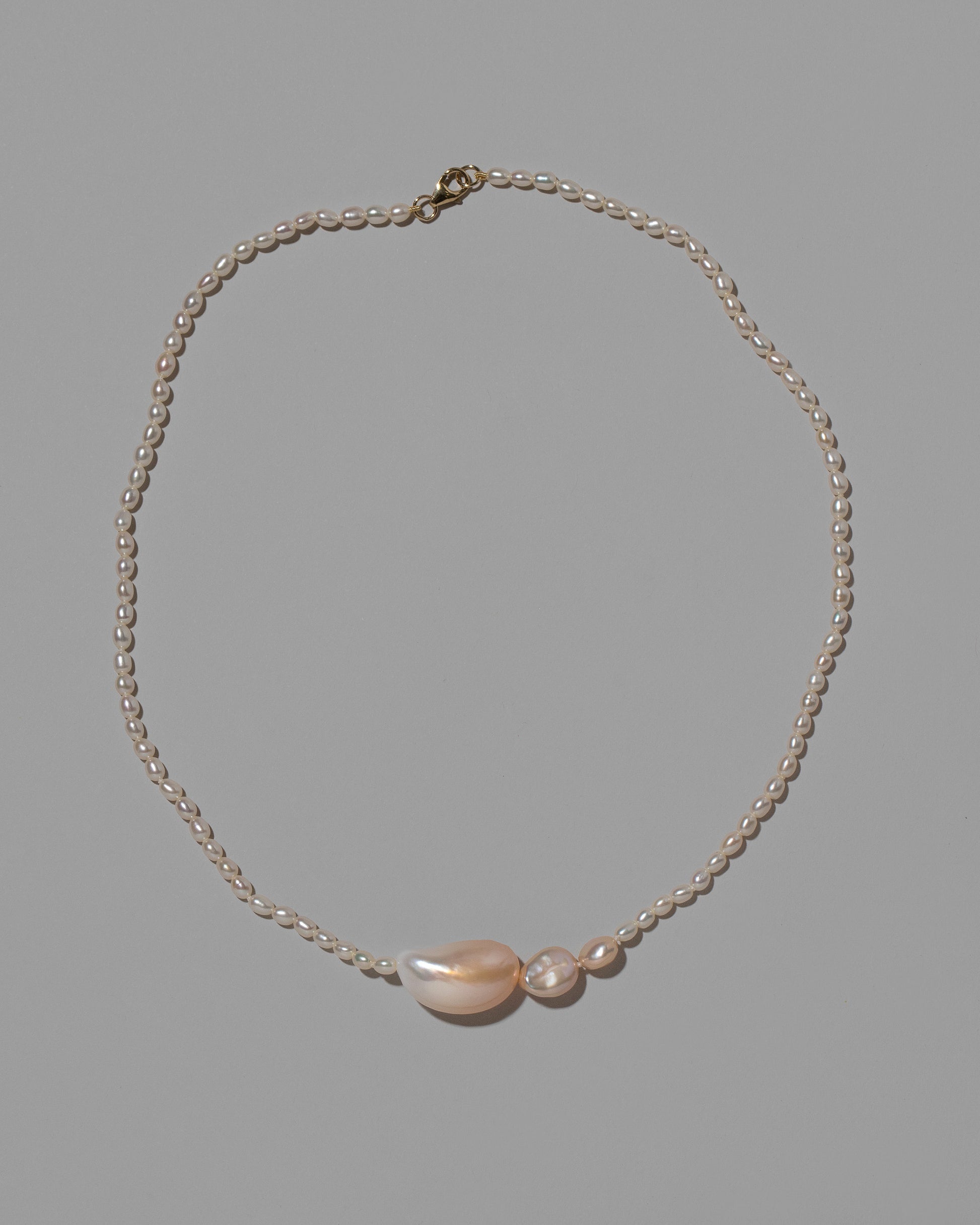 Nereus Pearl Necklace on light color background.