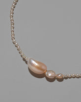 Nereus Pearl Necklace on light color background.