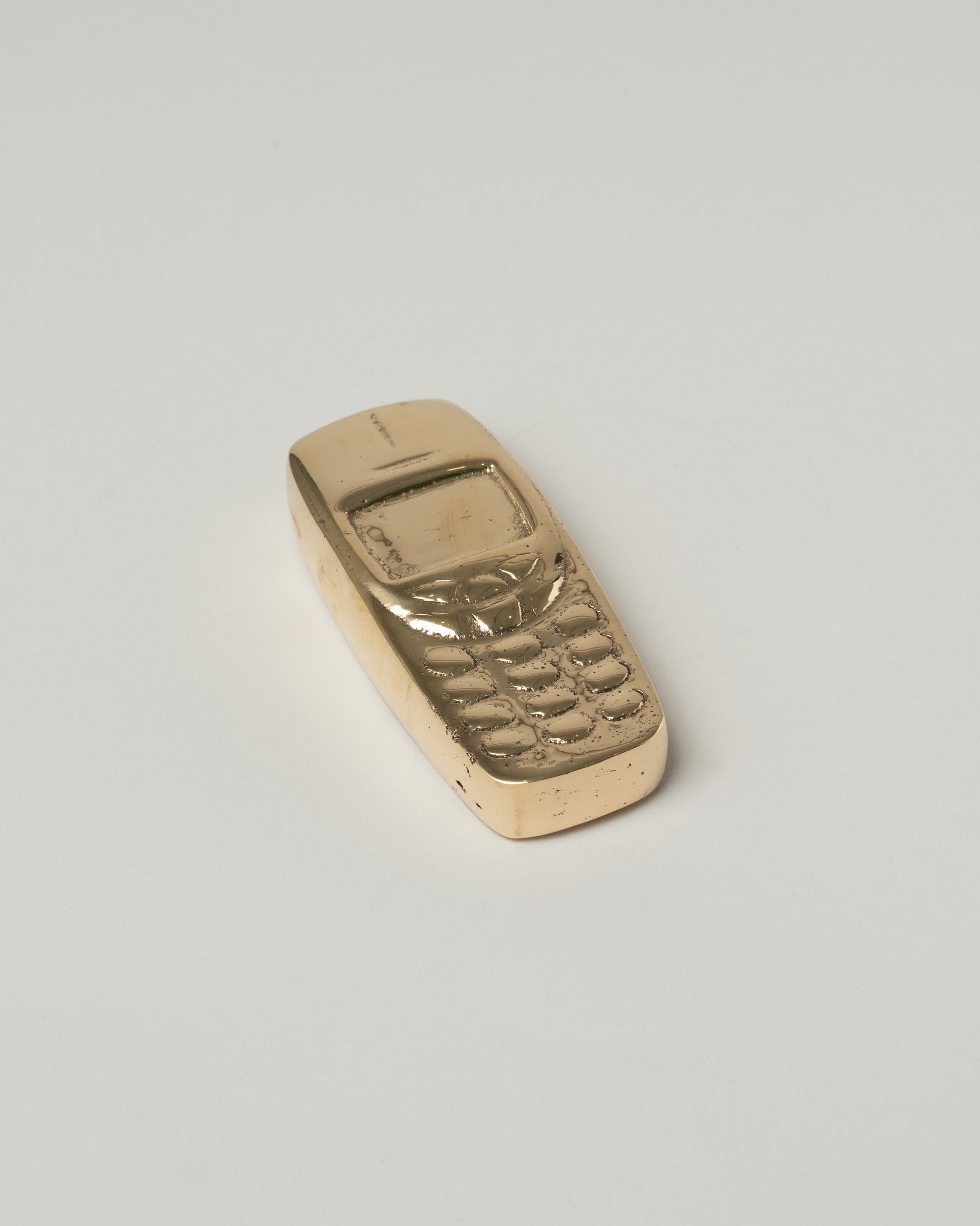 Pearce Objects Cast Bronze Nokia™ Brick Phone on light color background.