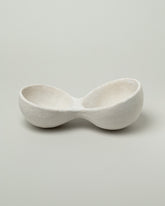 Closeup details of the Nur Ceramics White Nabra Double Bowl on light color background.