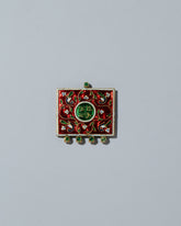 Antique Enamel Symbol Pendant on light color background.