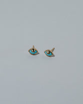 Samples & Imperfects Eye See You Stud Earrings on light color background.