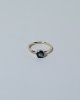 Samples & Imperfects 14k Yellow Gold Round Blue Sapphire Ring on light color background.