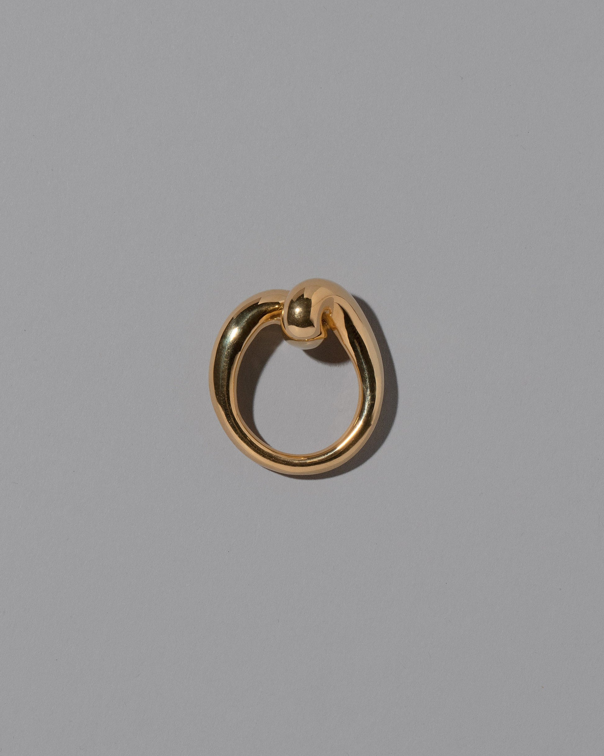 View from the side of the CRZM Gold Landform Ring on light color background.