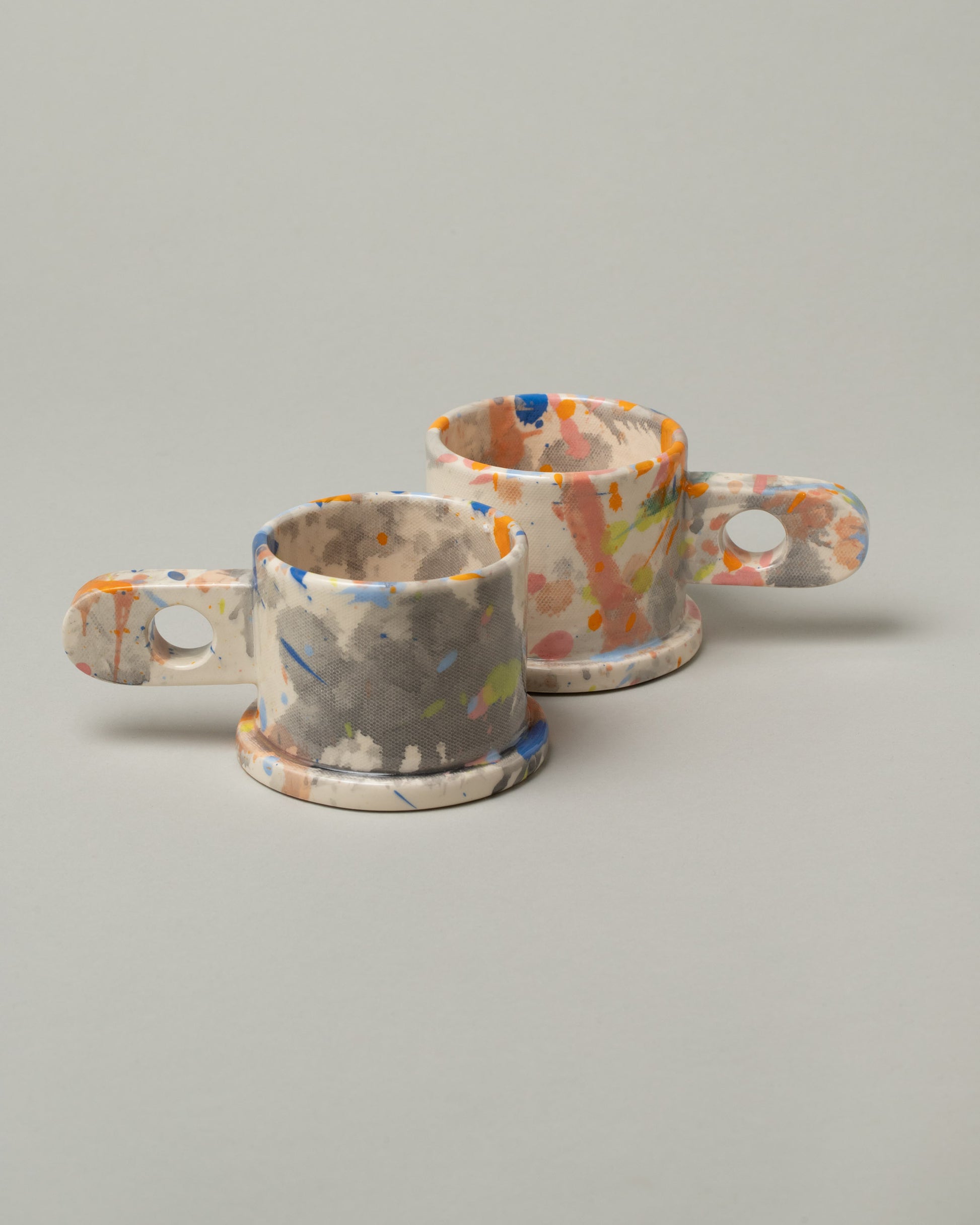 Group of Echo Park Pottery by Peter Shire Splatter Mugs on light color background.