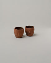 Rami Kim Raw Red Soju Cup Set on light color background.