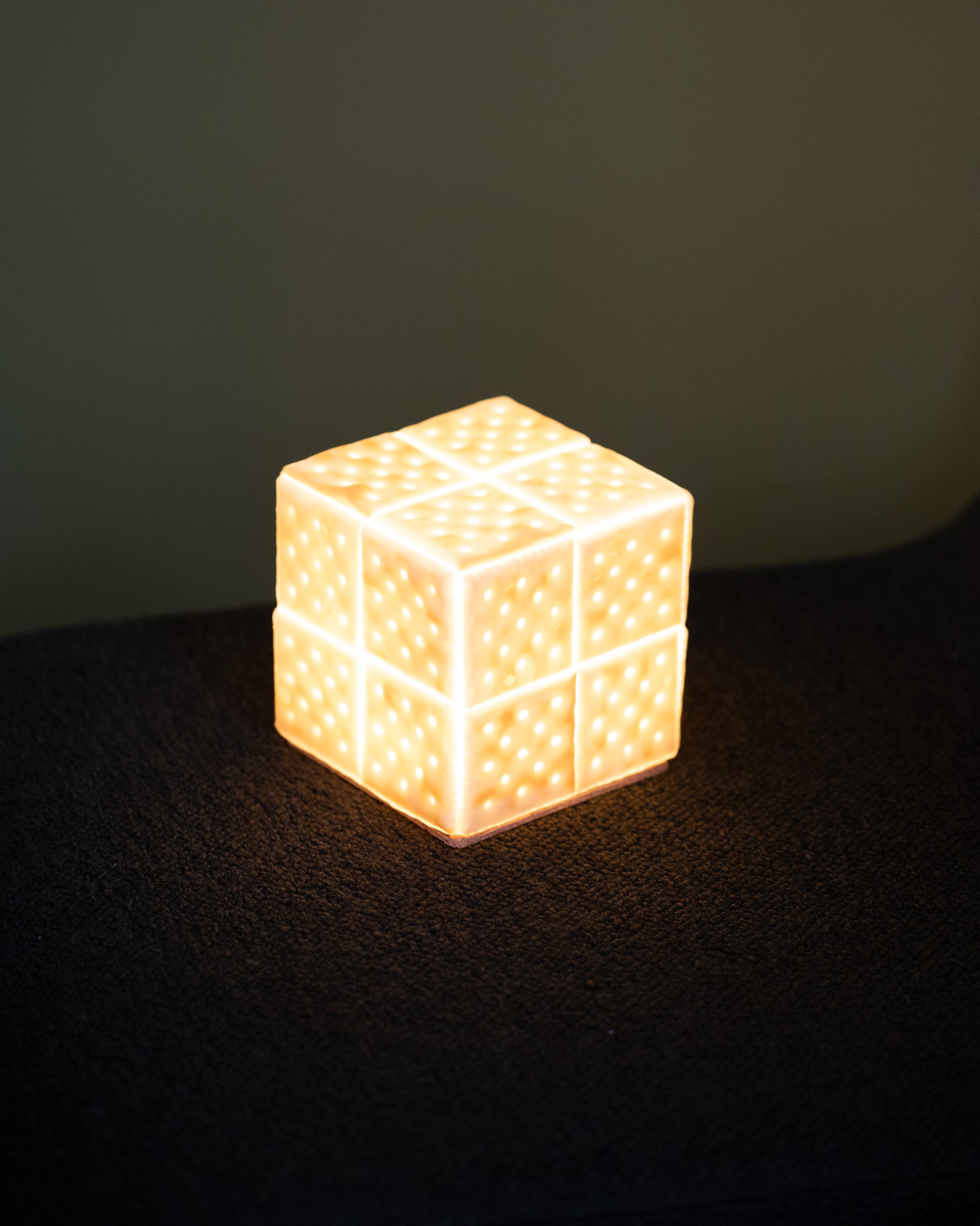 Detail view of the lit Pampshade Small For Your Pleasure Saltine Lamp on light color background.