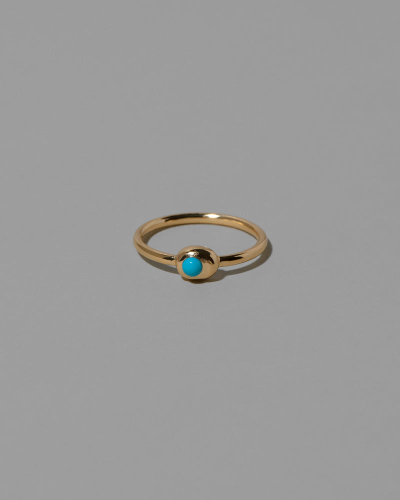 Turquoise Cabochon Birthstone Level Ring on light color background.