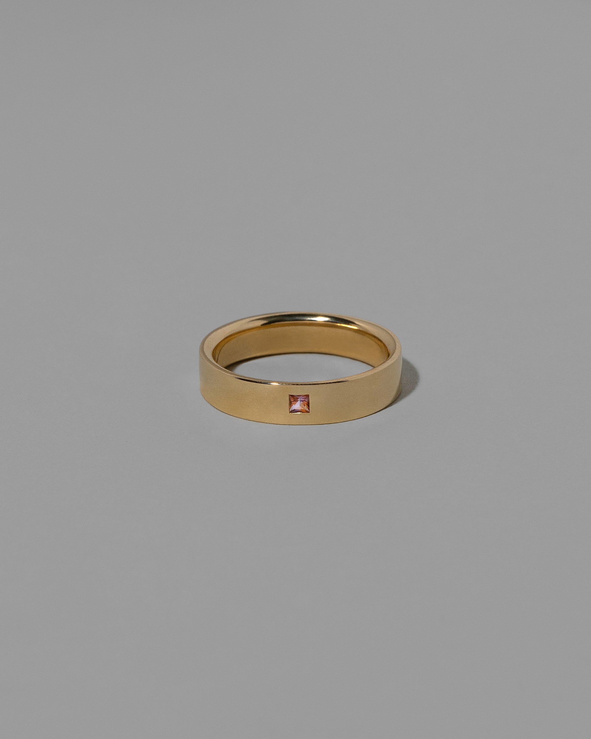 Gold Bicolor Peach Pink Sapphire 5mm Square Cut Piet Band on light color background. Note bicolor sapphires are unique in color; variations from this example should be expected and embraced.