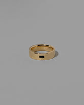 Gold Black Spinel East West 6mm Baguette-Set Piet Band on light color background.