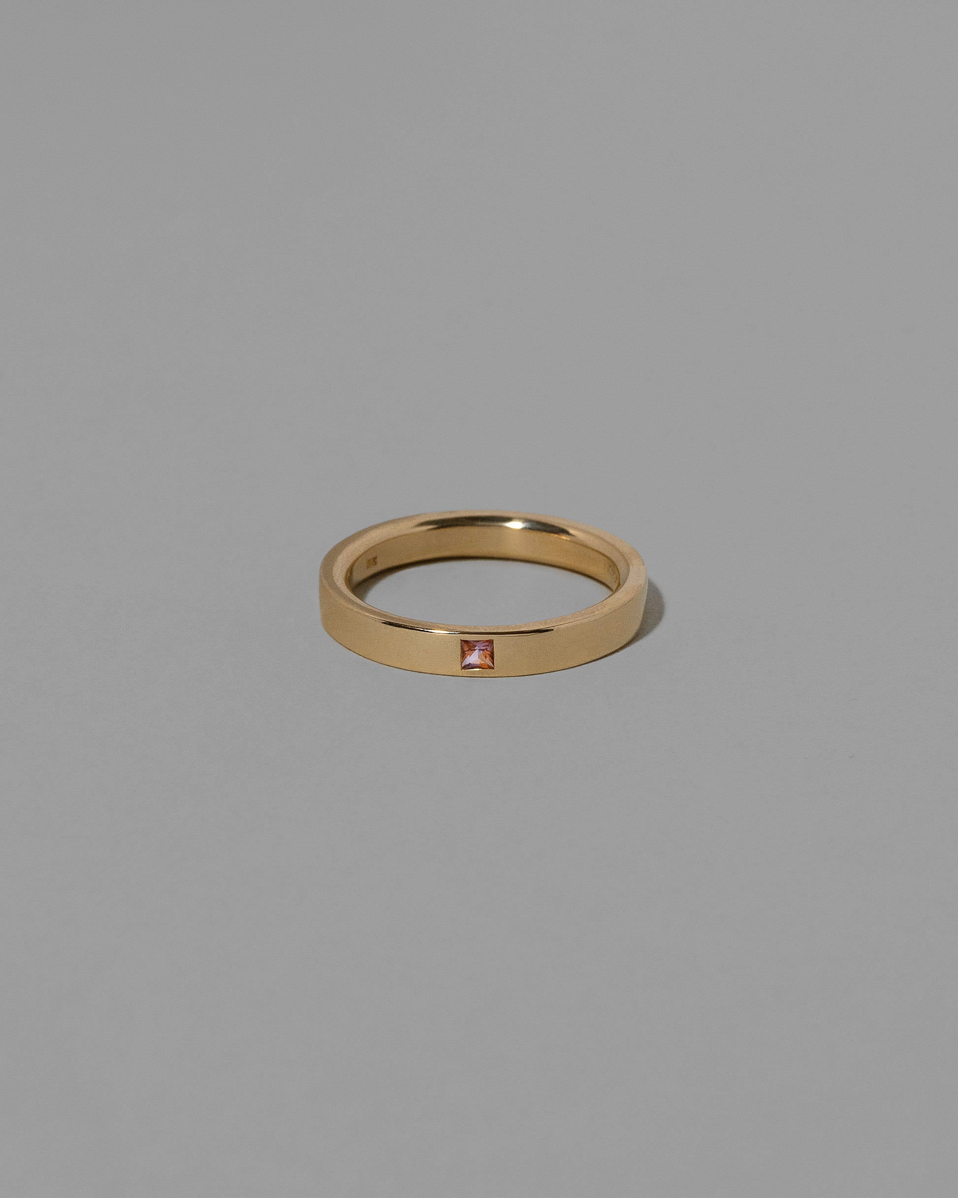 Gold Bicolor Peach Pink Sapphire 3mm Square Cut Piet Band on light color background. Note bicolor sapphires are unique in color; variations from this example should be expected and embraced.