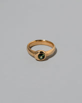 Green Sapphire Level Ring on light color background.