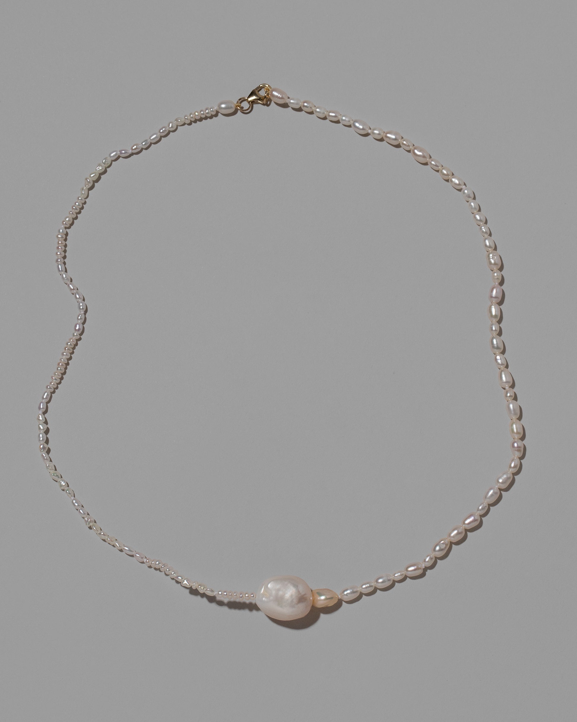 Pontus Pearl Necklace on light color background.