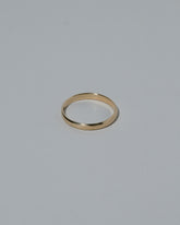 Samples & Imperfects 2.5mm 14k Yellow Gold Half Round Band on light color background.