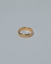 Samples & Imperfects 5.2mm Yellow Gold Half Round Band on light color background.