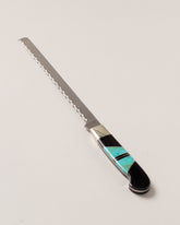 Santa Fe Stoneworks Jet & Turquoise Bread Knife on light color background.