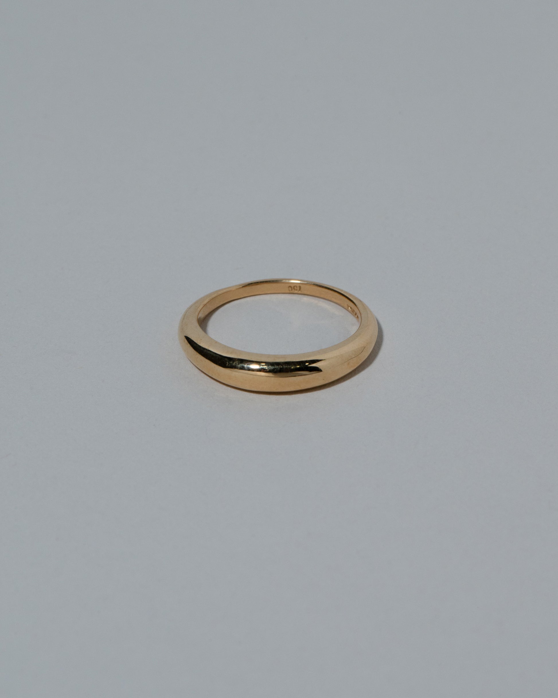 Samples & Imperfects 5mm 18k Yellow Gold Venus Band on light color background.