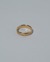 Samples & Imperfects 14k Yellow Gold Tahiti Band on light color background.