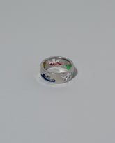 View from the side of the Samples & Imperfects Sterling Silver Multicolor Enamel Pattern Band on light color background.