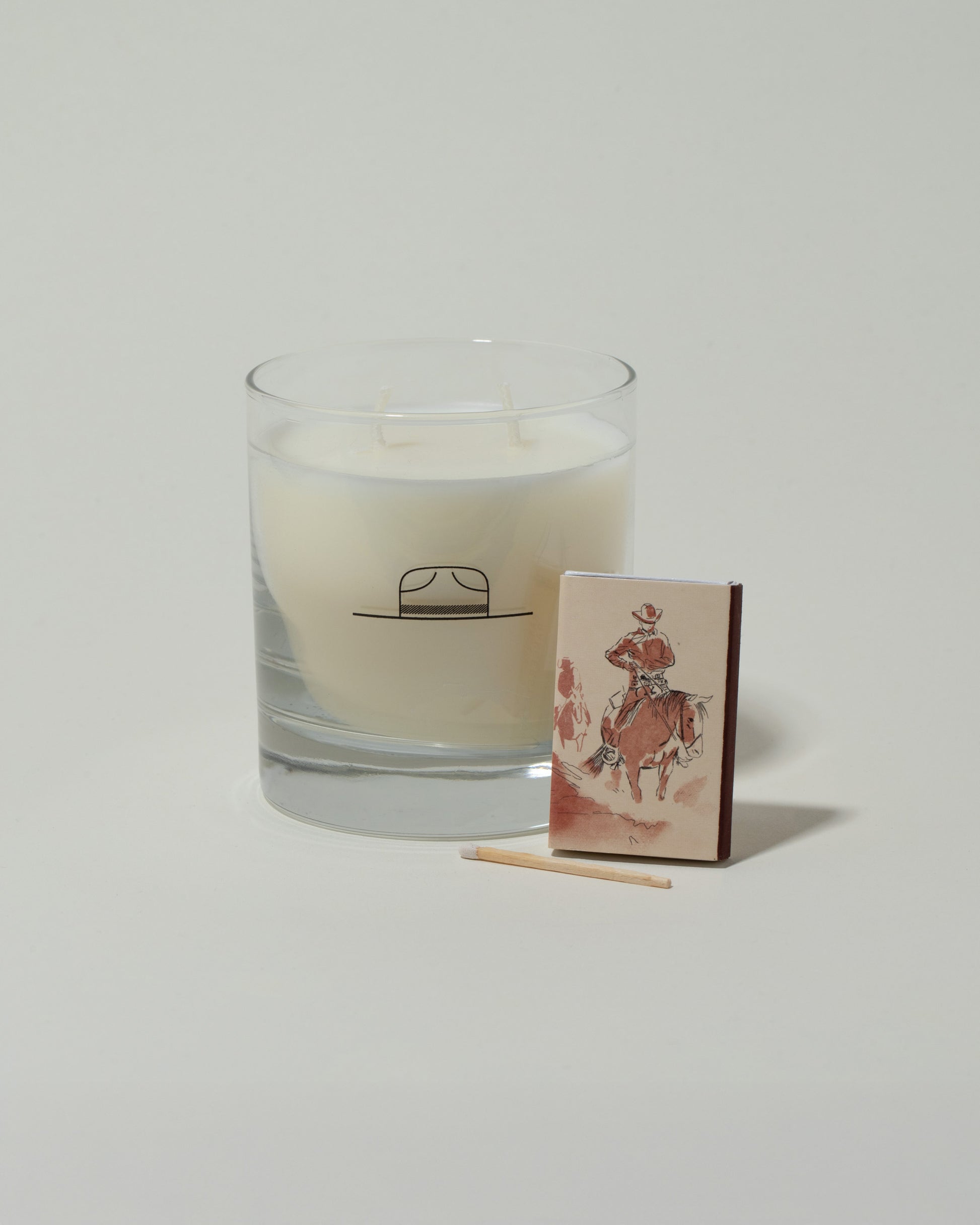 Closeup details of the Ranger Station Sandalwood & Bergamot Candle with matchbox on light color background.