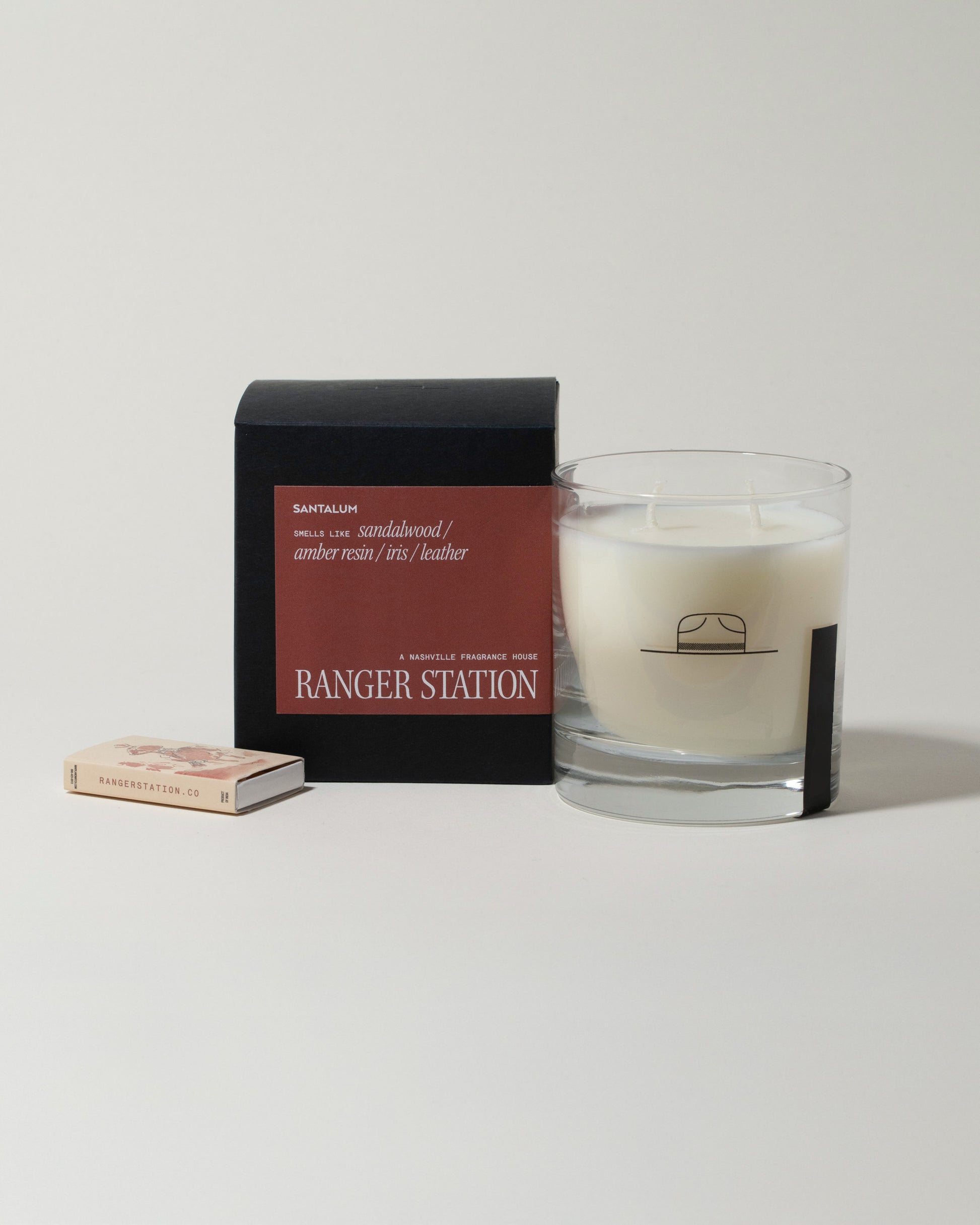Ranger Station Santalum Candle with matchbox on light color background.