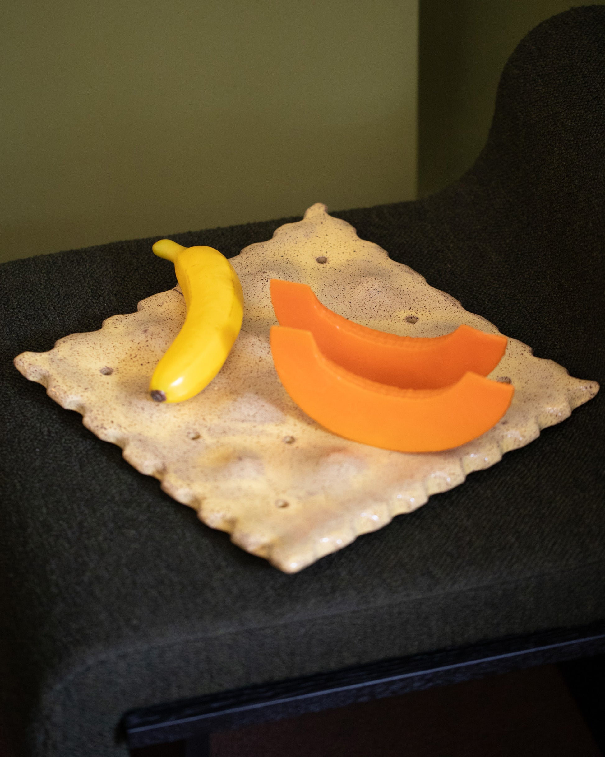 Styled image featuring the Recreation Center For Your Pleasure Big Saltine Fruit Tray with artificial fruit.