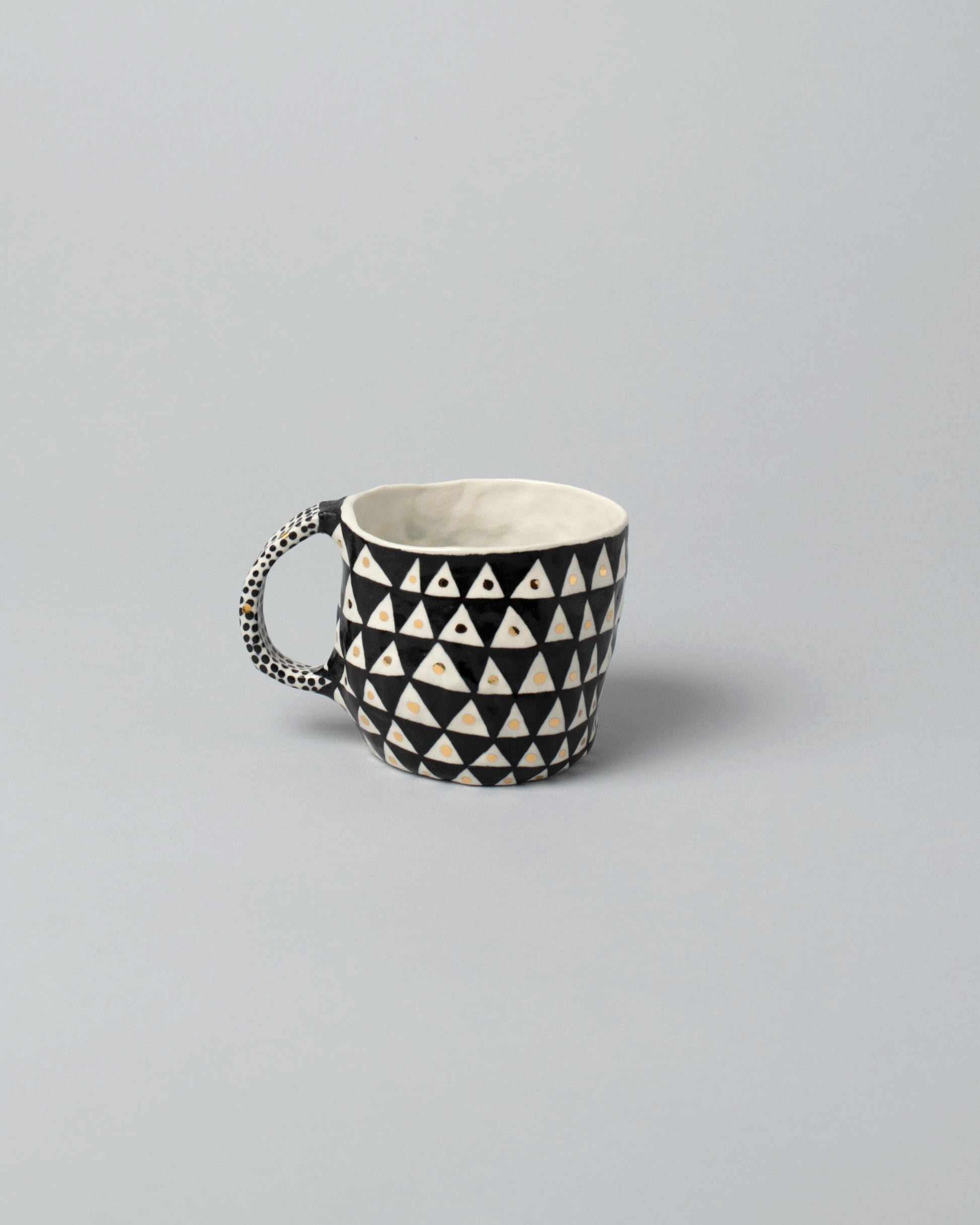 Suzanne Sullivan One Mug on light color background.