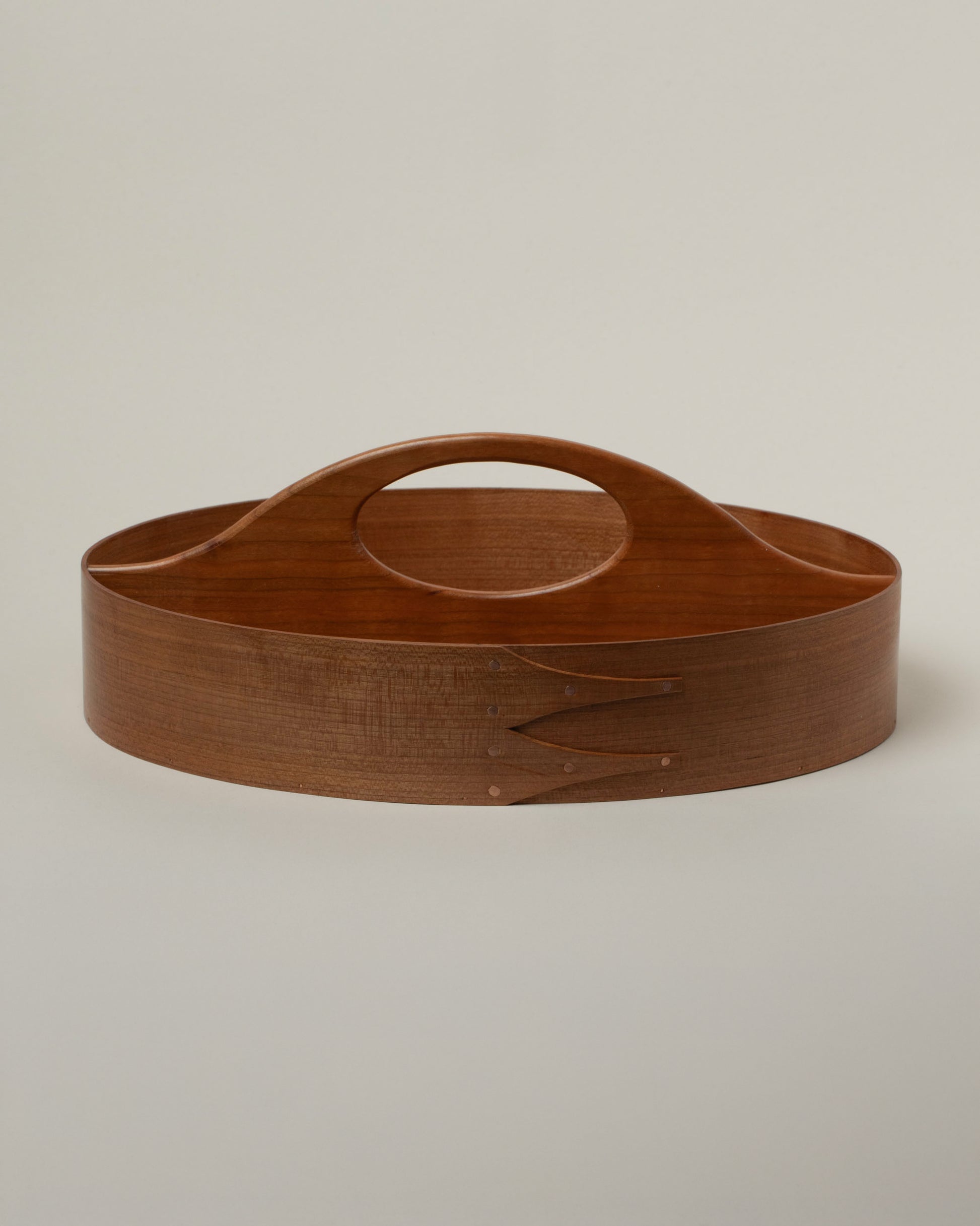 Rikke Falkow Cherry Wood Two-Sided Carrier on light color background.