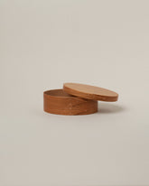 Detail view of the Rikke Falkow 6" Cherry Wood Oval Box on light color background.