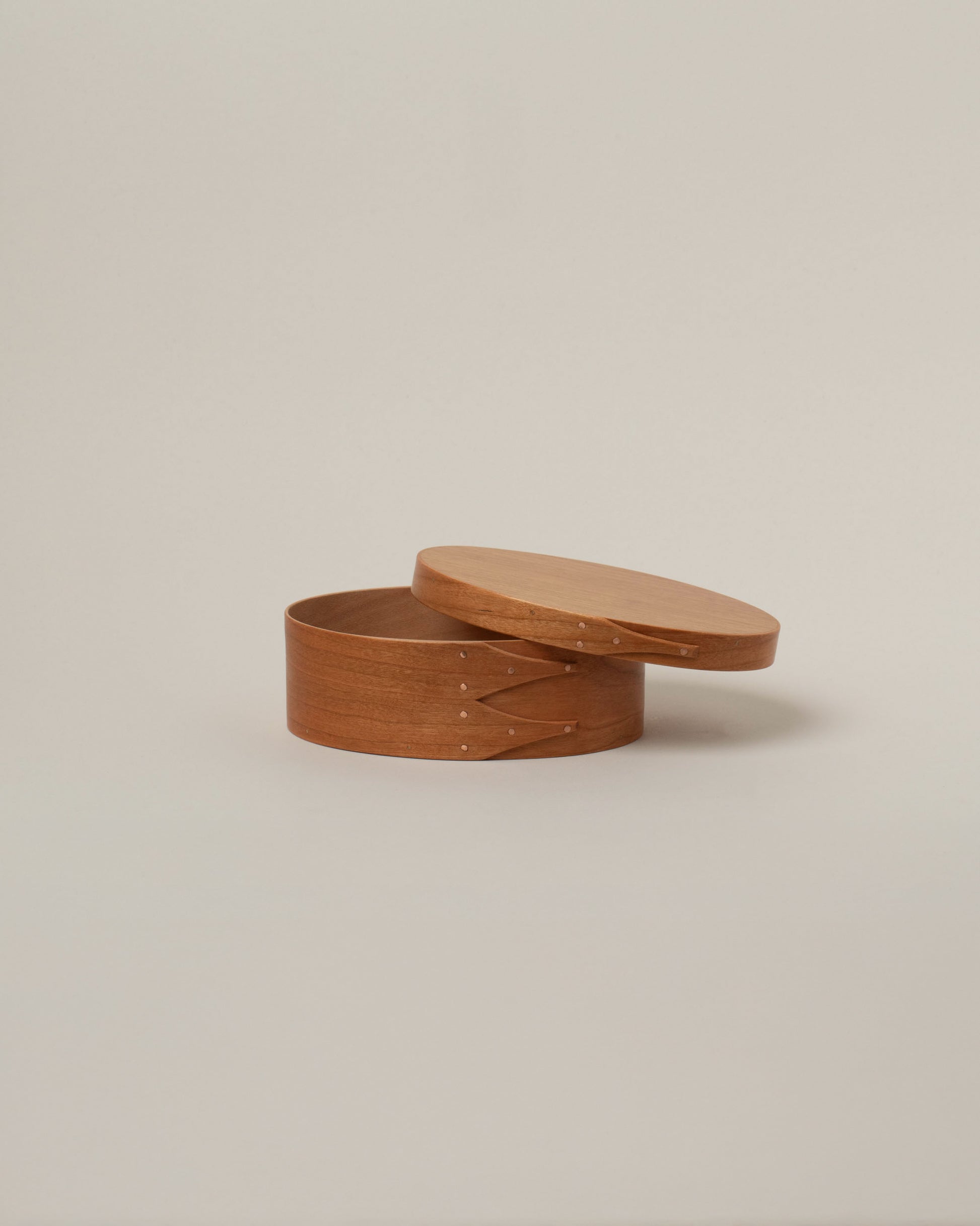 Detail view of the Rikke Falkow 6" Cherry Wood Oval Box on light color background.