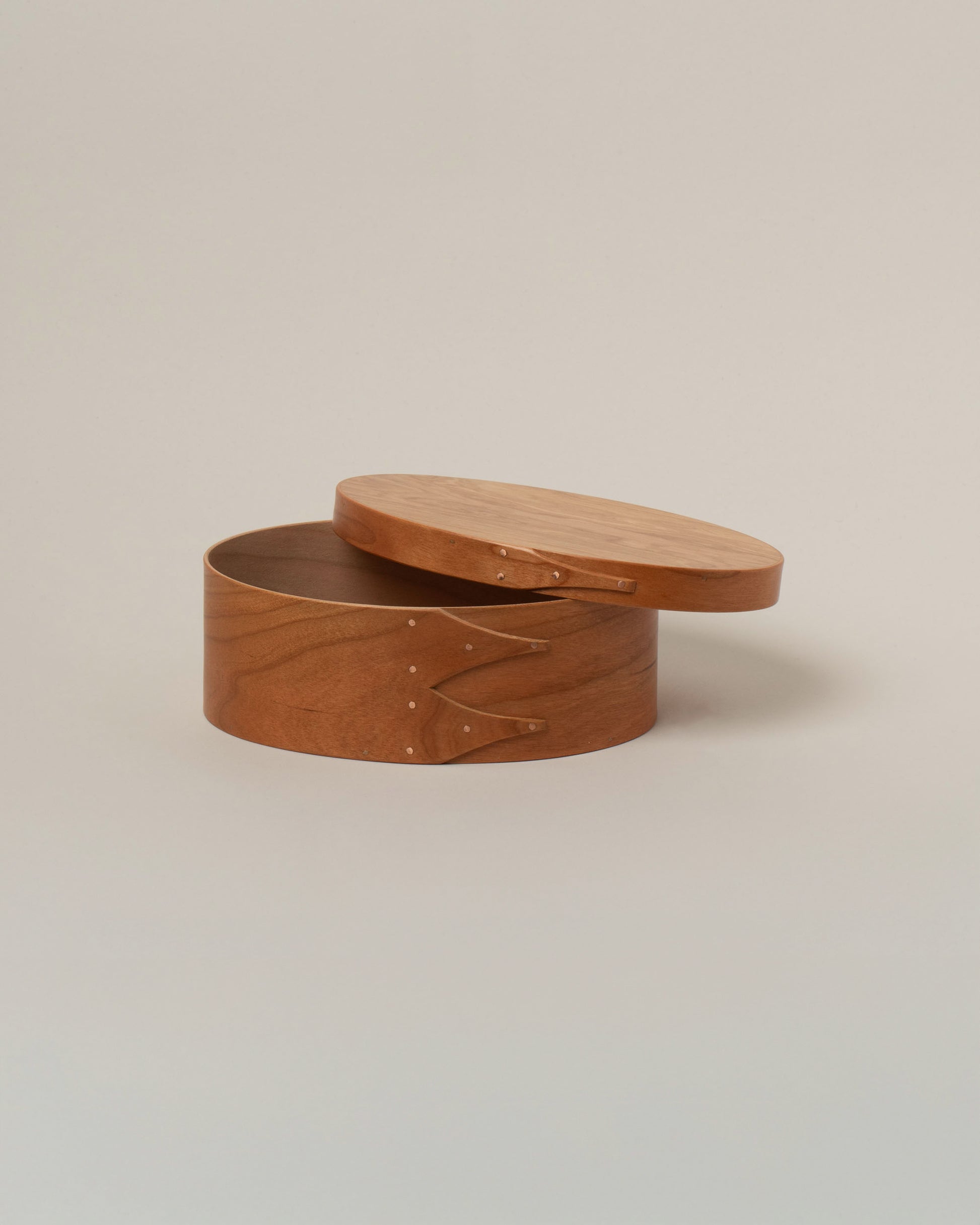 Detail view of the Rikke Falkow 7" Cherry Wood Oval Box on light color background.