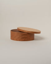 Detail view of the Rikke Falkow 9" Cherry Wood Oval Box on light color background.