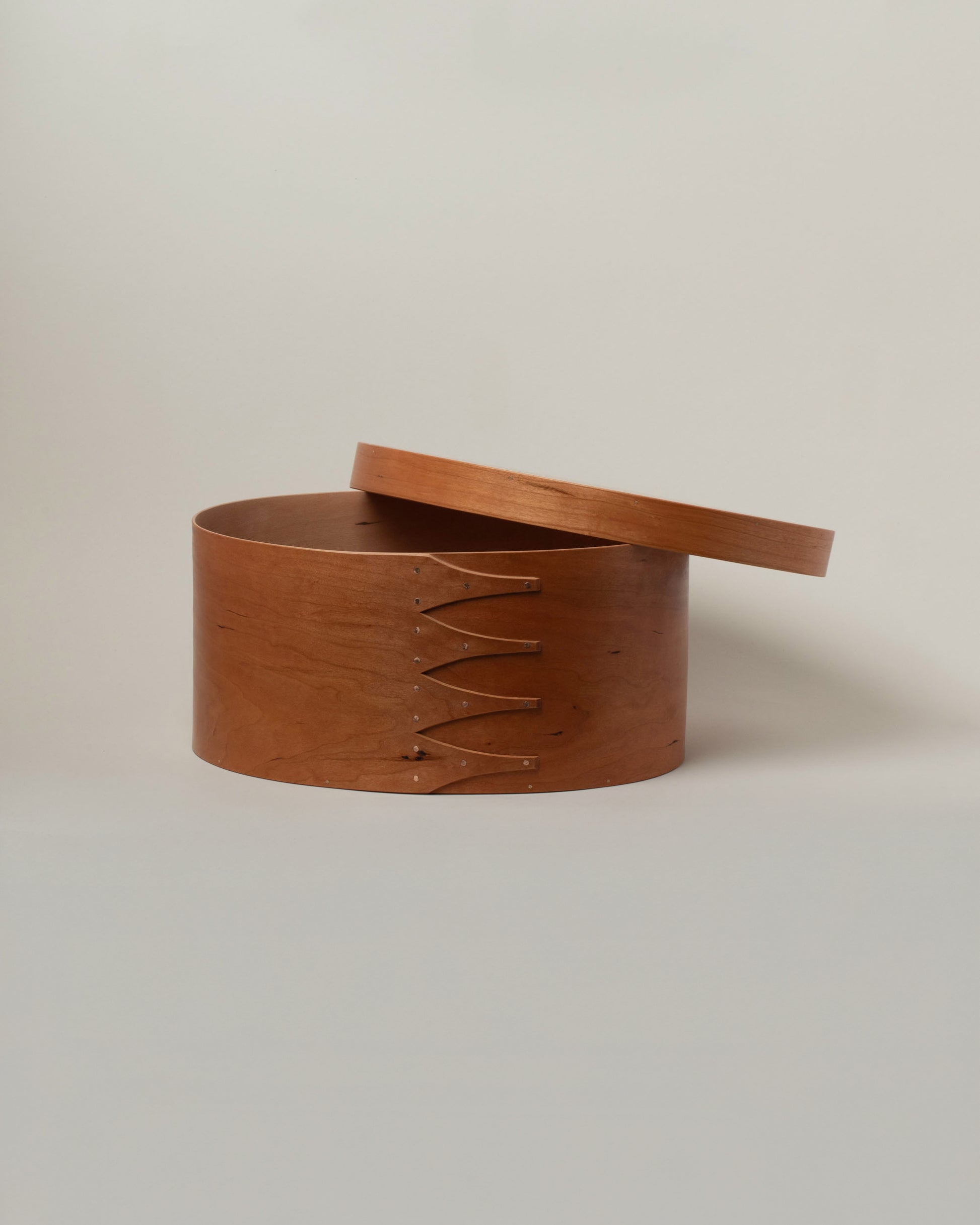 Detail view of the Rikke Falkow 13" Cherry Wood Oval Box on light color background.