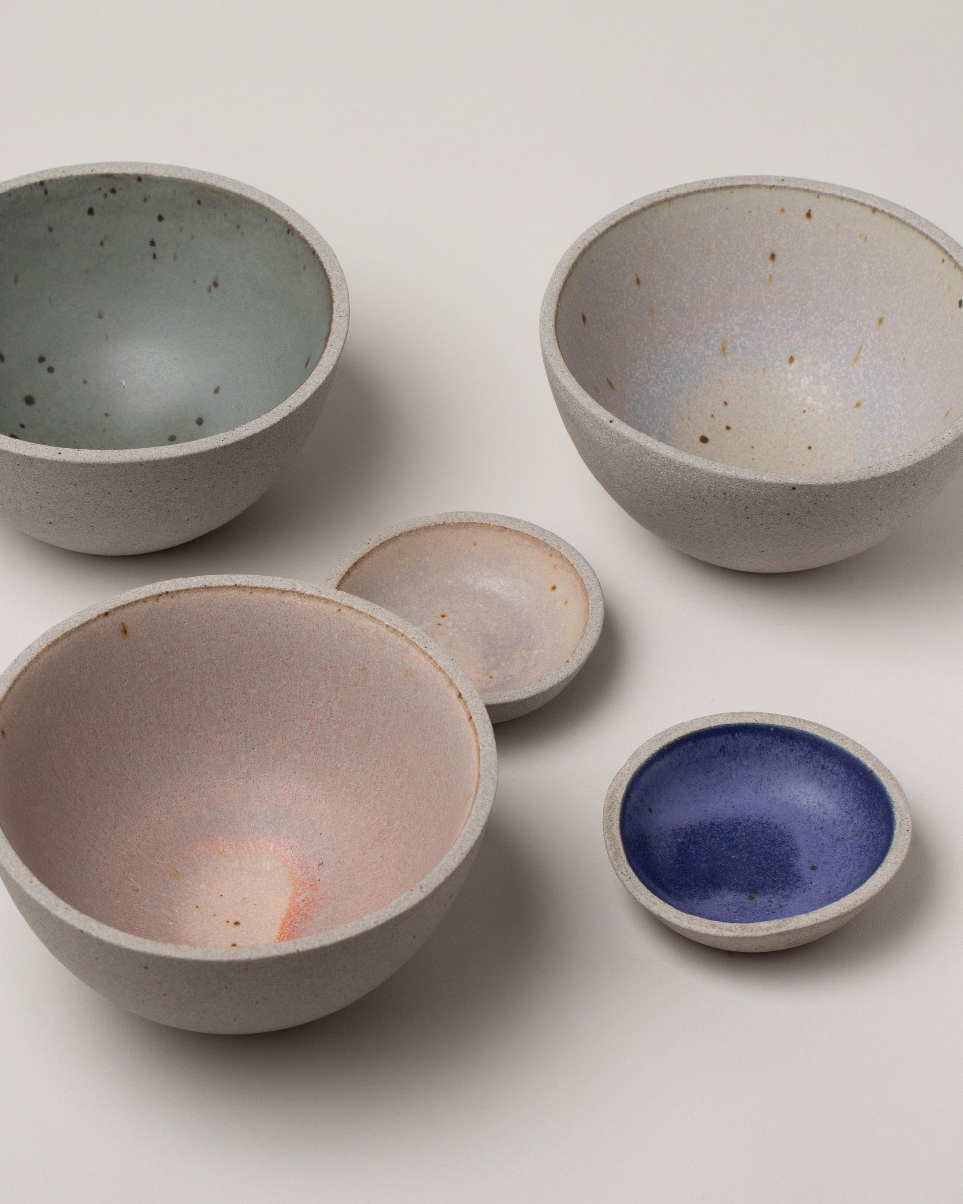 Group of Humble Ceramics Mini Stillness Bowls and Enoki Bowls on light color background.