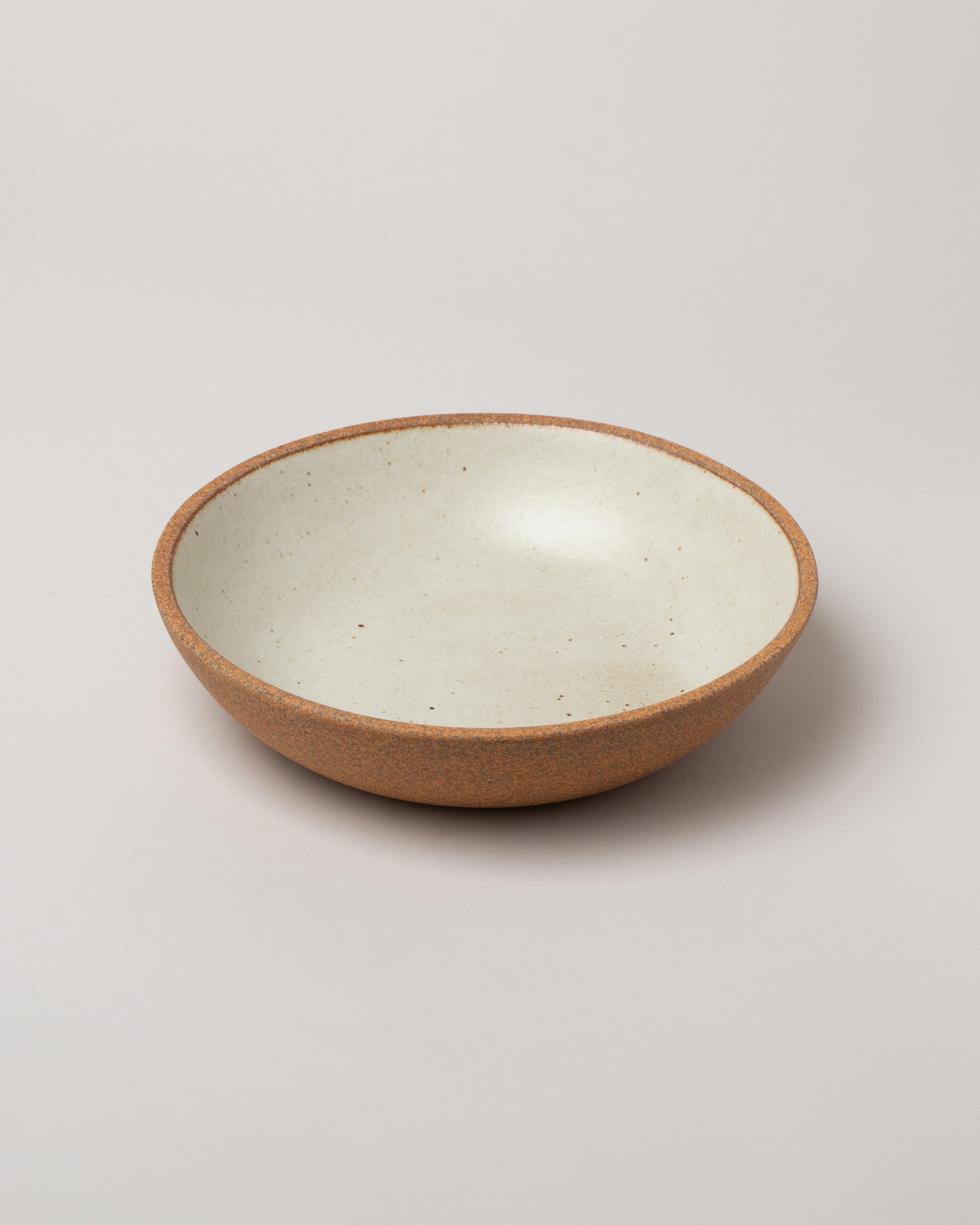 Humble Ceramics Sandstone & Snow White Stillness Bowl on light color background.