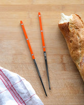 Styled image featuring the Sabre Paris Orange Chopsticks.