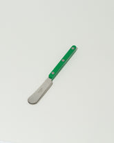 Sabre Paris Garden Green Butter Spreader on light color background.