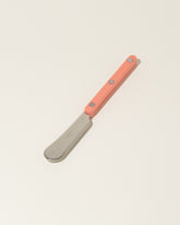 Sabre Paris Nude Pink Butter Spreader on light color background.