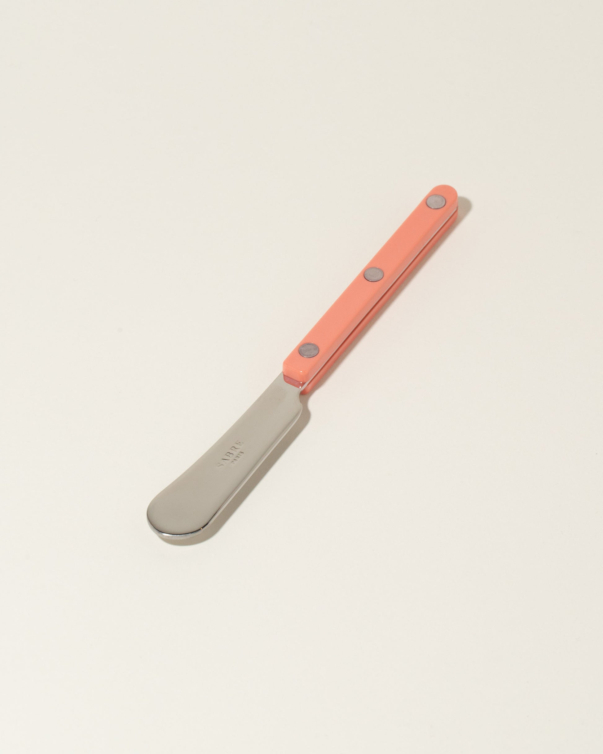 Sabre Paris Nude Pink Butter Spreader on light color background.