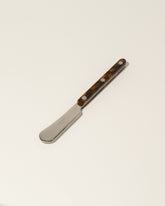 Sabre Paris Faux Tortoise Butter Spreader on light color background.