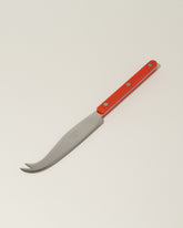 Sabre Paris Red Cheese Knife on light color background.