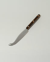 Sabre Paris Faux Tortoise Cheese Knife on light color background.