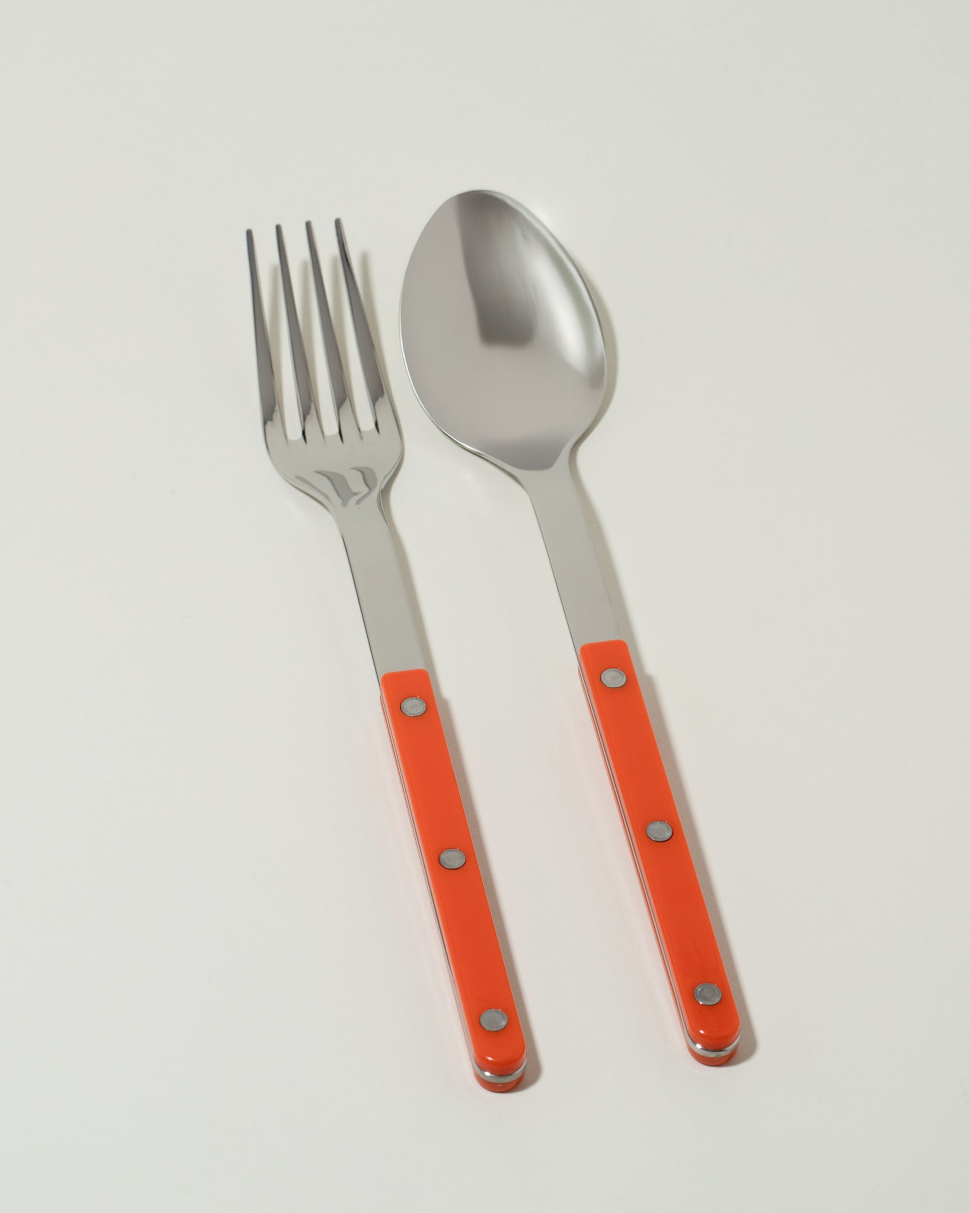 Sabre Paris Orange Serving Set on light color background.