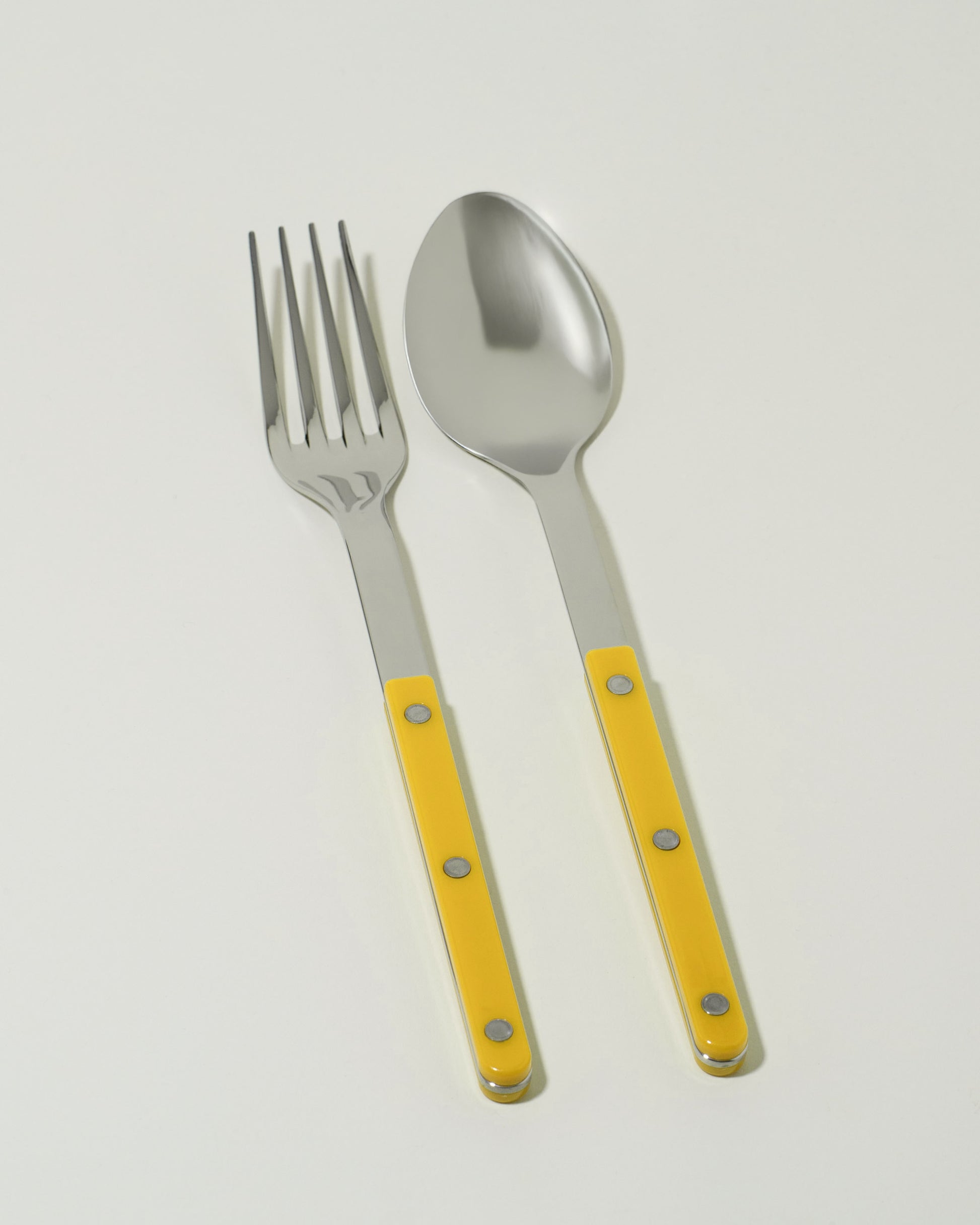 Sabre Paris Yellow Serving Set on light color background.