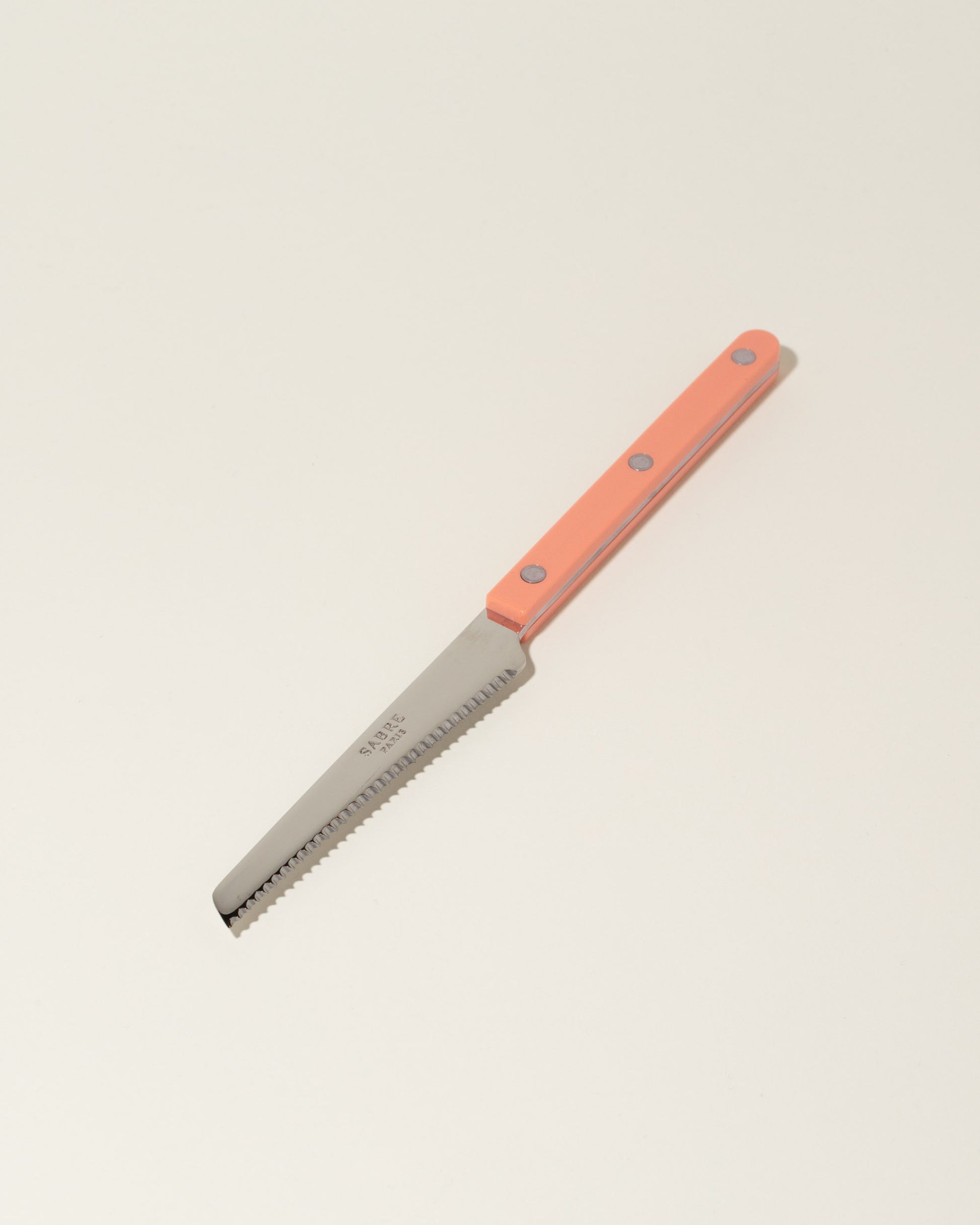Sabre Paris Nude Pink Tomato Knife on light color background.