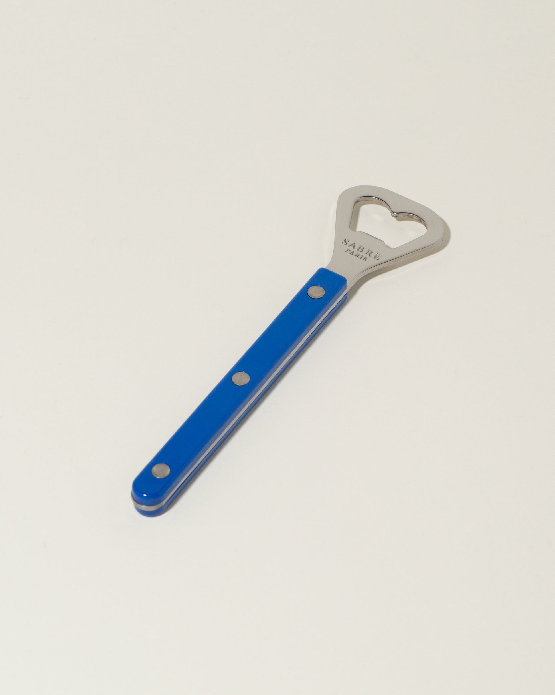 Sabre Paris Lapis Blue Bottle Opener on light color background.