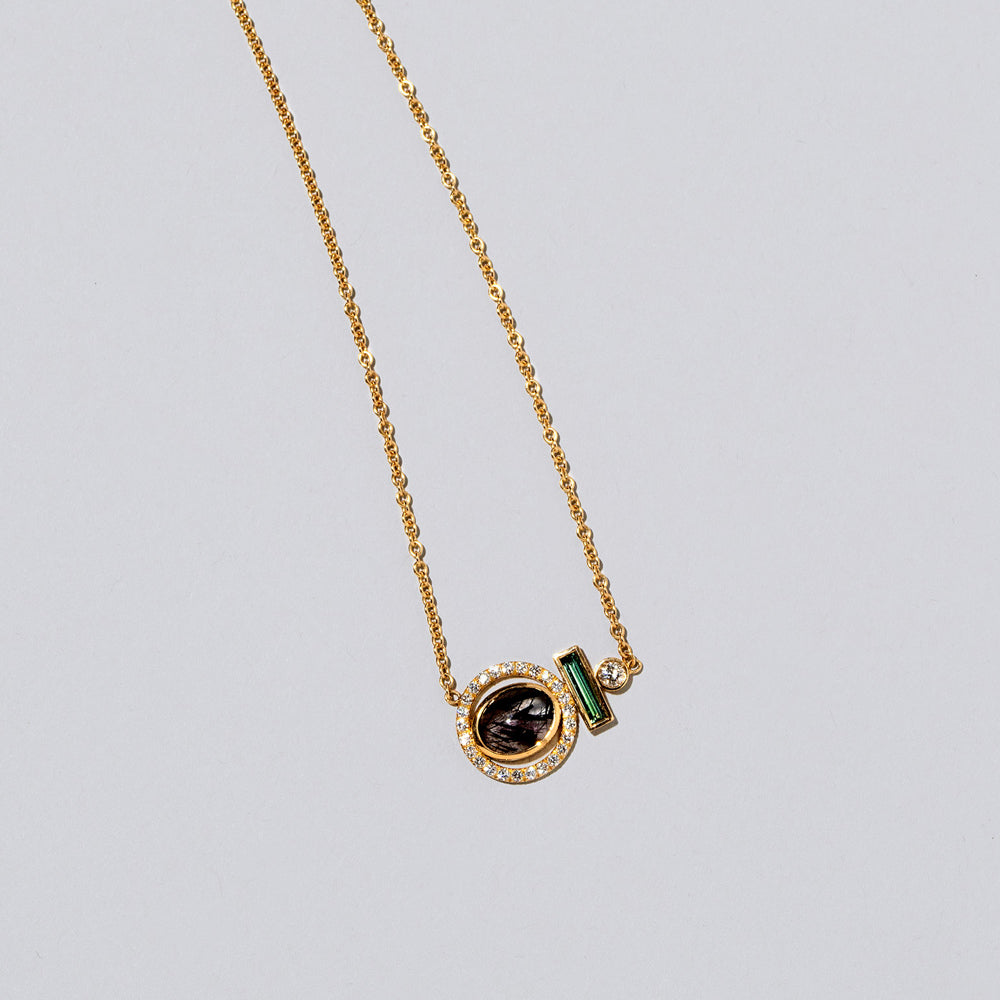 product_details::Closeup view of the Mystical Change Necklace on light color background.