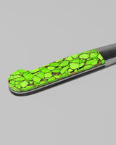 Closeup details of the Santa Fe Stoneworks Neon Ranger Bread Knife on light color background.