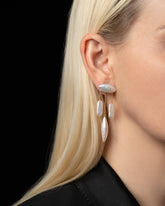 Egret Pearl Earrings on model.